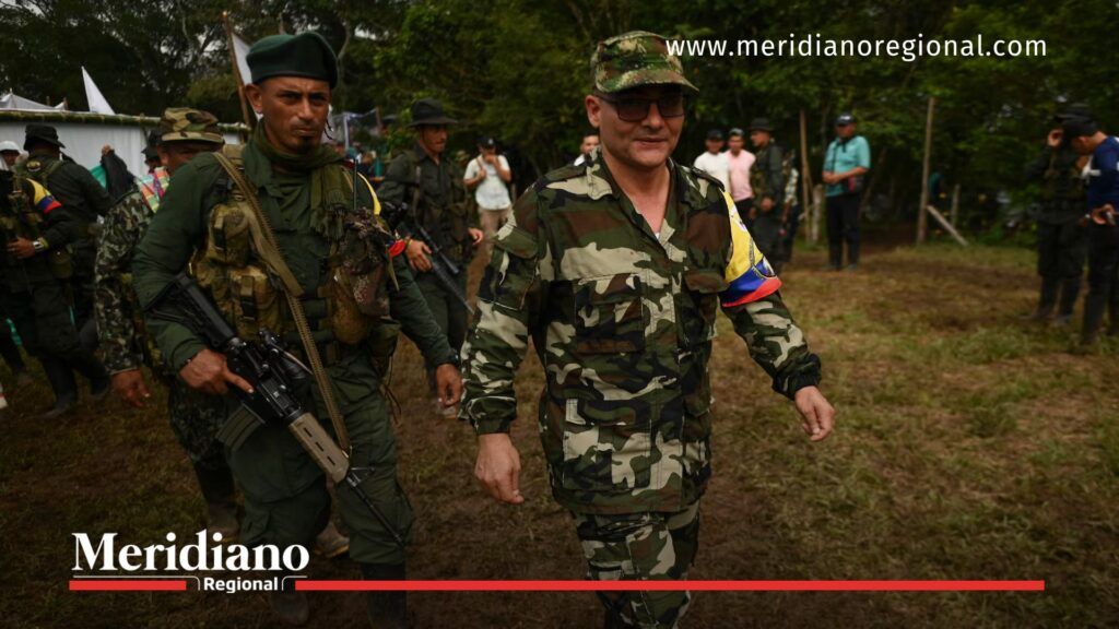 Iván Mordisco caminando en un campamento guerrillero del EMC en zona selvática.