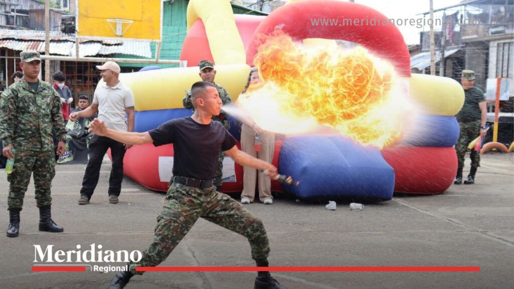 soldado realizando presentación controlada con fuego durante la entrega kits deportivos en el asentamiento Gustavo Restrepo