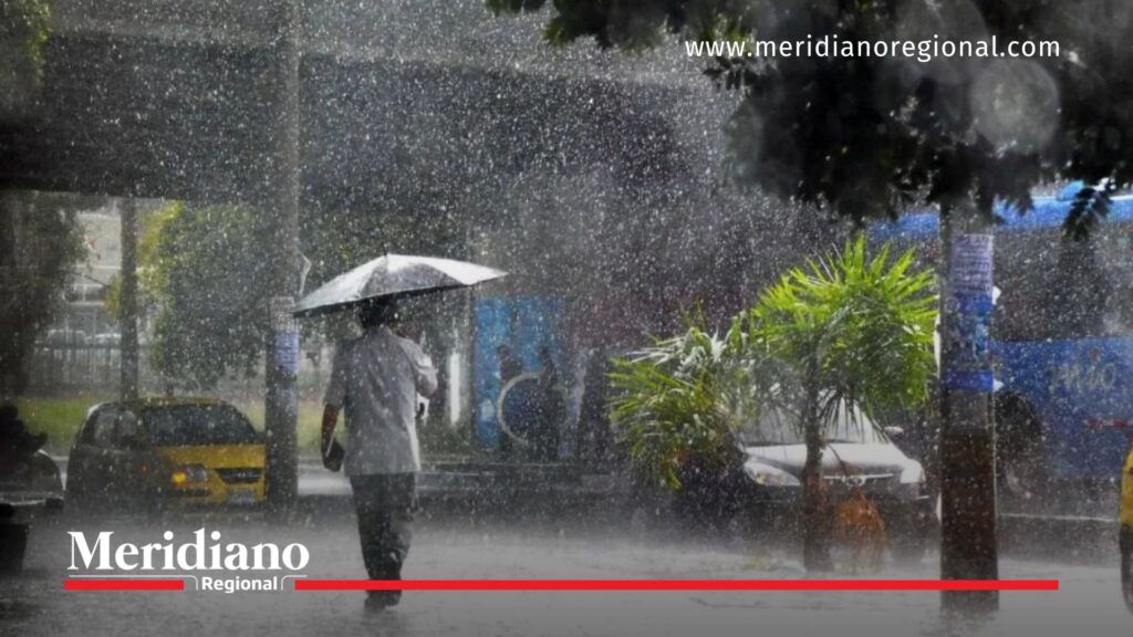 Lluvias en el suroccidente colombiano afectan a Cali - Meridiano Regional Persona camina con sombrilla bajo lluvias en el suroccidente colombiano, en la ciudad de Cali