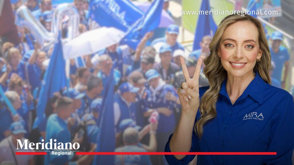 Ana Paola Agudelo en evento político del Partido Mira acompañada de seguidores con banderas azules