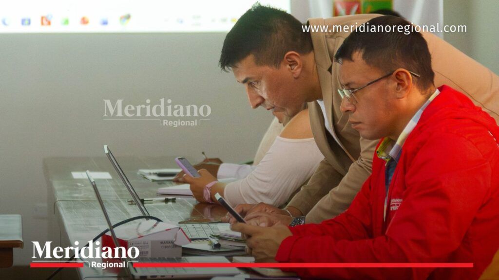 Funcionarios y representantes técnicos revisan información climática en computadores durante una Mesa Técnica Agroclimática realizada en el departamento del Cauca.